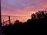 The train rail and trees in front of a colourful sky (161x)