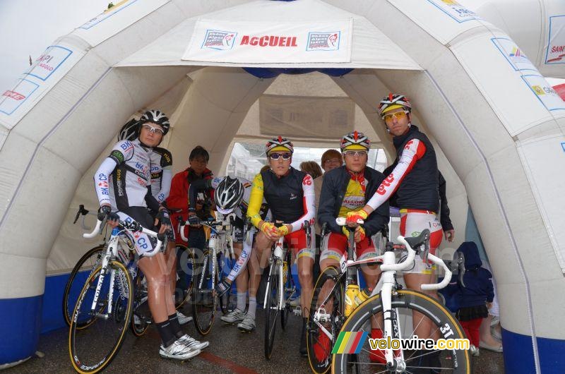 The riders hide for the rain before the start