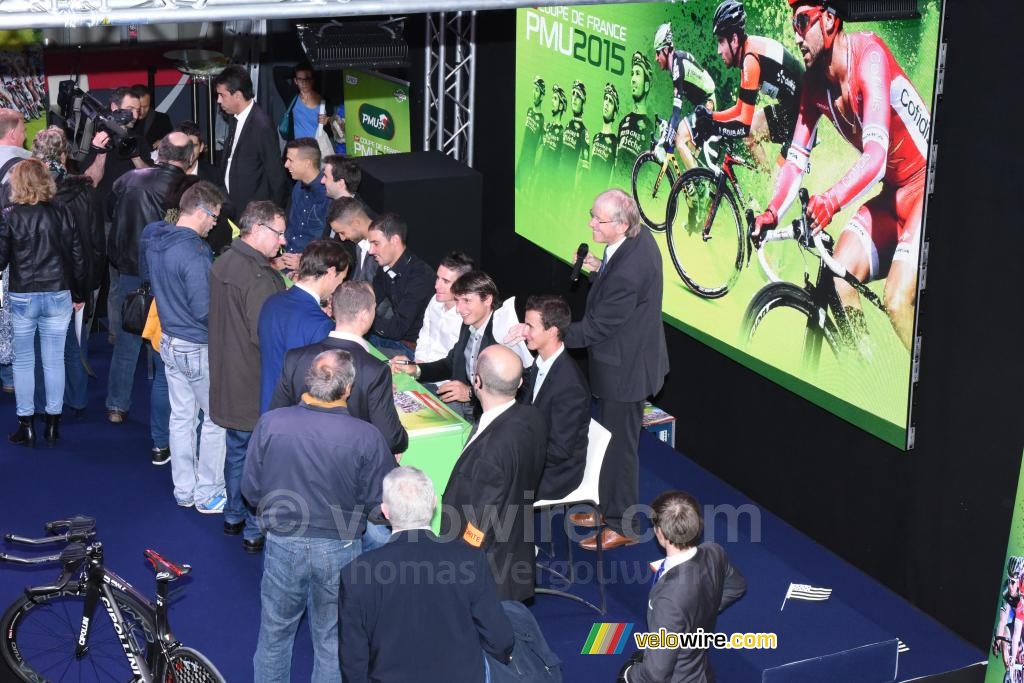 The riders take some time for a signing session (2)