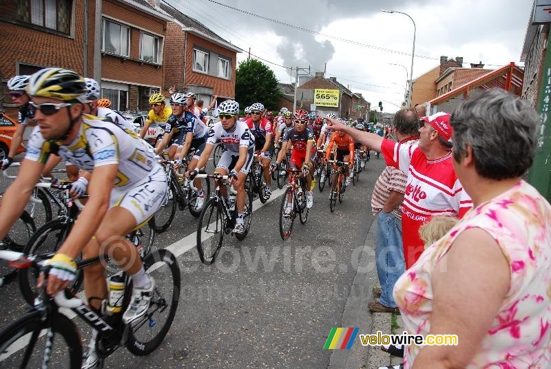 The peloton with Fabian Cancellara's yellow jersey in the feeding zone in Ampsin