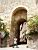 Isabelle in front of the city gate of Cordes-sur-Ciel (153x)