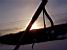 The sun going down behind the ski stick (468x)