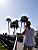 Romain on the phone in front of the palm trees (276x)