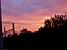 The train rail and trees in front of a colourful sky (156x)