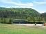 A lake in the middle of the forest and a ski lift (274x)