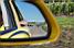 The pack of riders is coming - in the mirror of the Mavic car (584x)