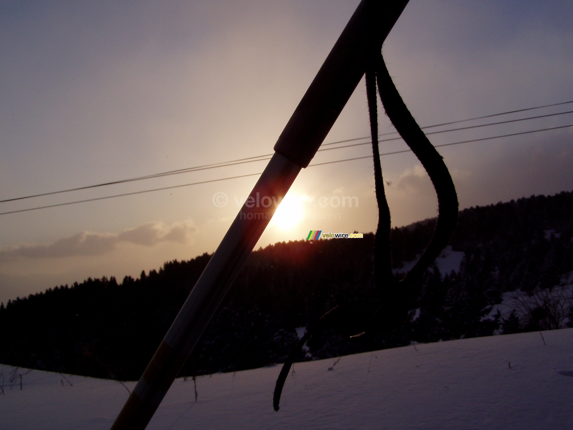 The sun going down behind the ski stick