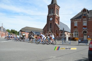 The peloton passes in front of the town hall and the church of Montay (2) (367x)