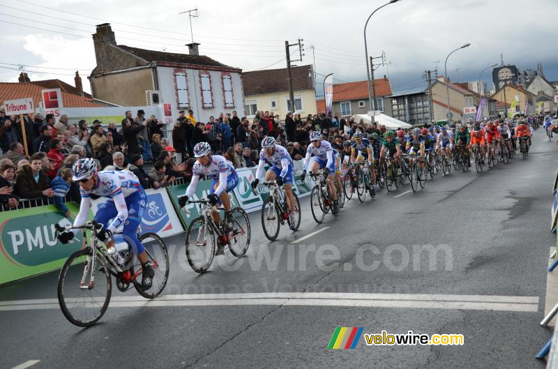 Het peloton bij de eerste doorkomst over de finishlijn