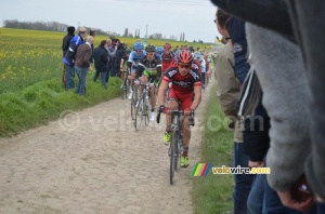The peloton getting to the end of cobble stones sector 20 (399x)