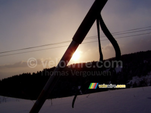 The sun going down behind the ski stick (410x)