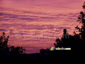 The overhead wire for the train in front of a colourful sky (251x)