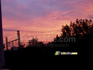 The train rail and trees in front of a colourful sky (219x)