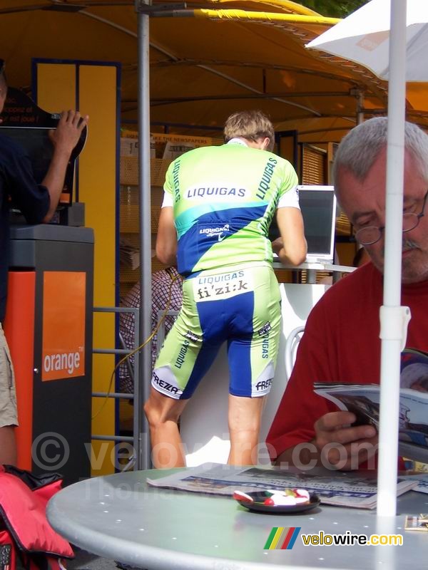 In the Village Départ the cyclists check their e-mail at the Orange stand