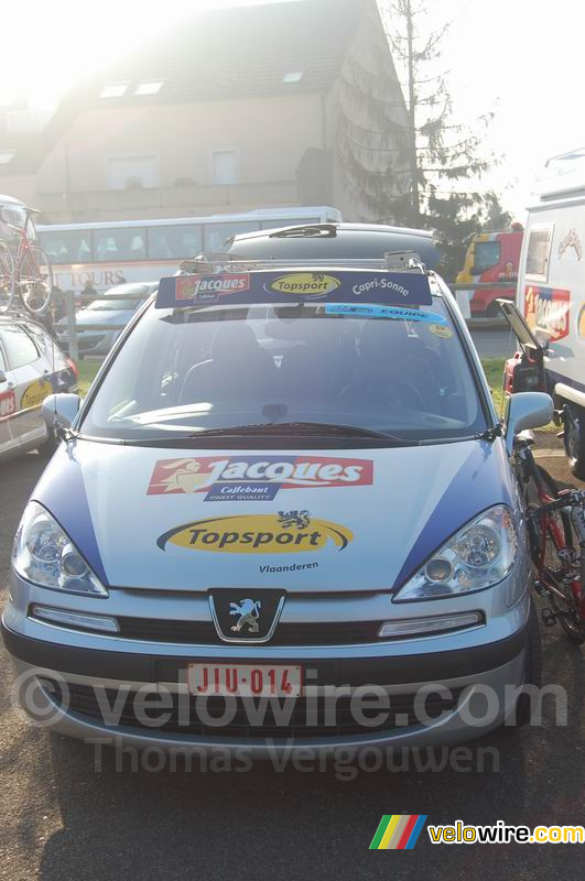 A car of the Chocolade Jacques cycling team