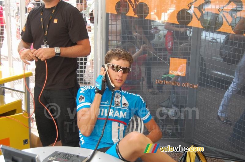 Niki Terpstra (Milram) on the phone in the Orange stand in the Village Départ