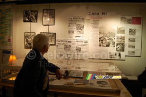 Raymond Poulidor looks at press clippings from his time as a professional cyclist (1037x)