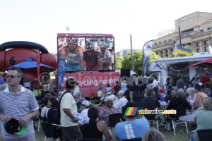 People watching the race summary on a big screen in the TDU village (407x)